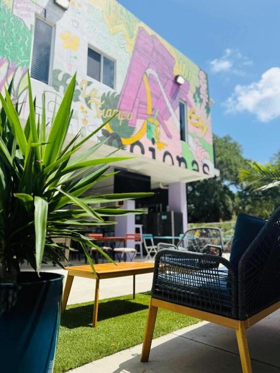 Painted facade and outdoor seating area at Atrium